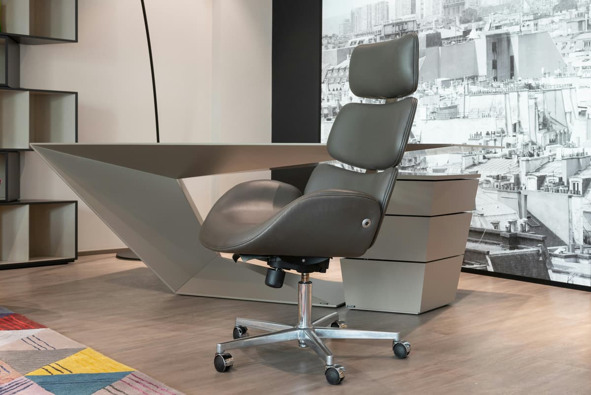 A modern ergonomic chair in front of a clean home office desk setup.