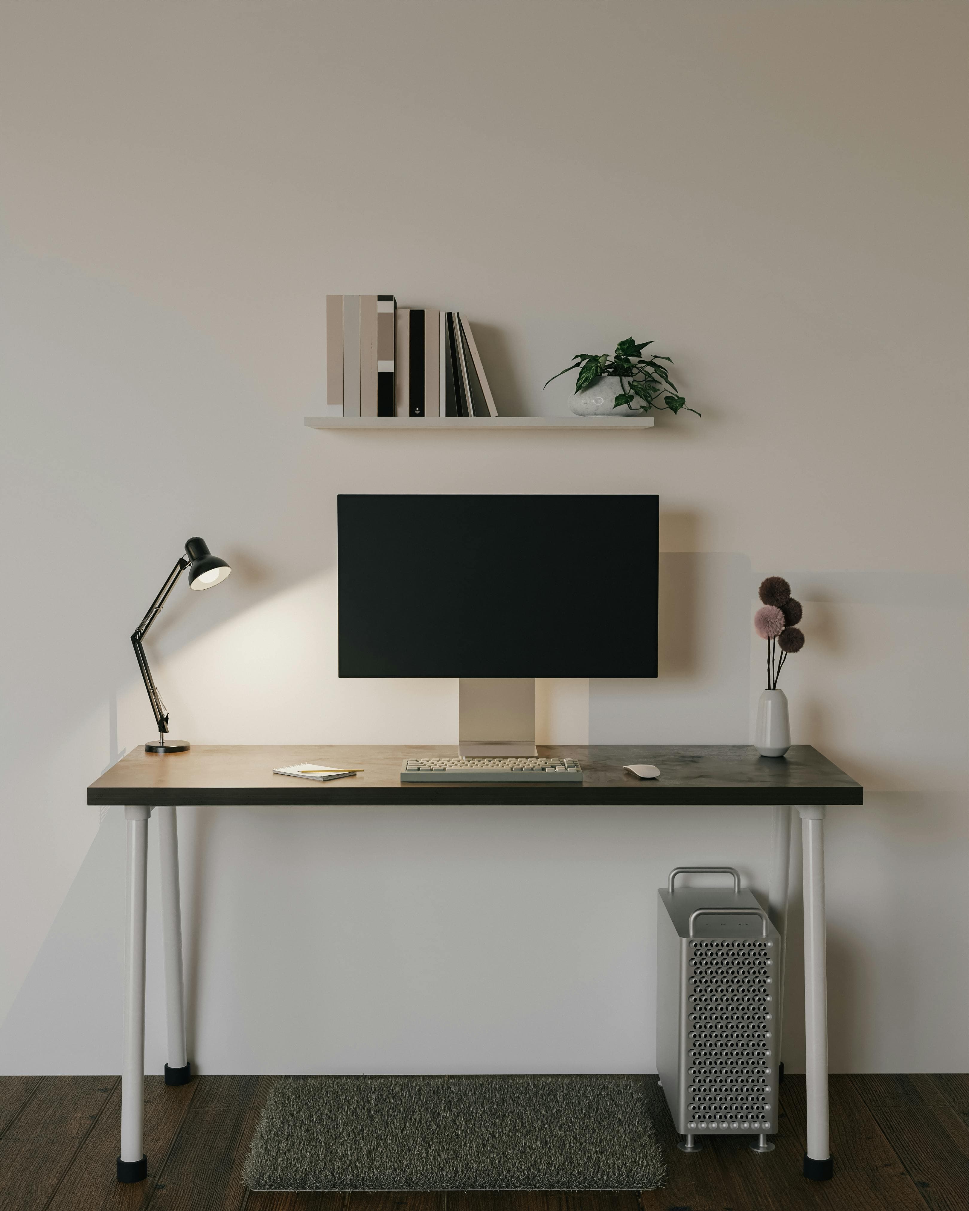 A compact apartment desk setup arranged neatly in a small room.