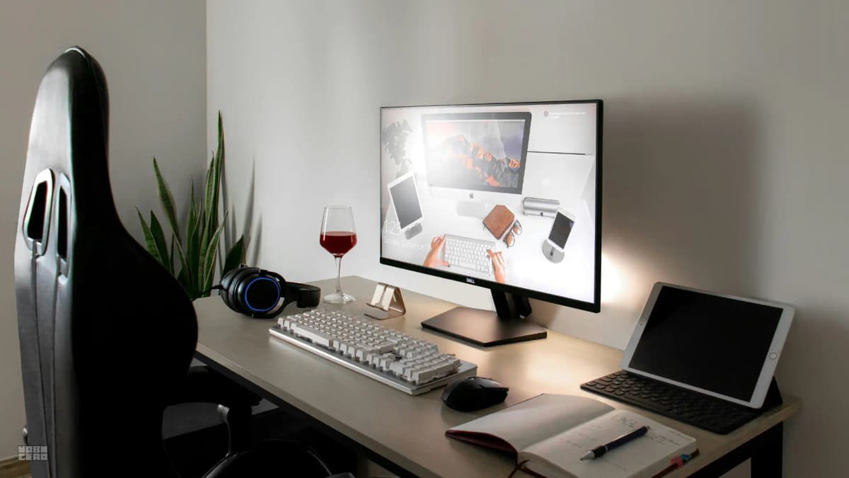 A side view of a desk showing the distance between a monitor and a user's seating position.