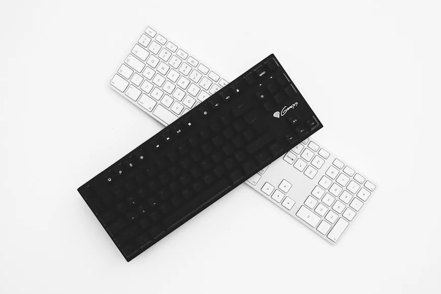 A compact desk setup with a keyboard and mouse on a wooden work surface.