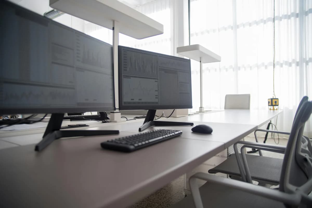 A deep office desk setup with dual monitors, keyboard, and mouse arranged with extra front-to-back space.