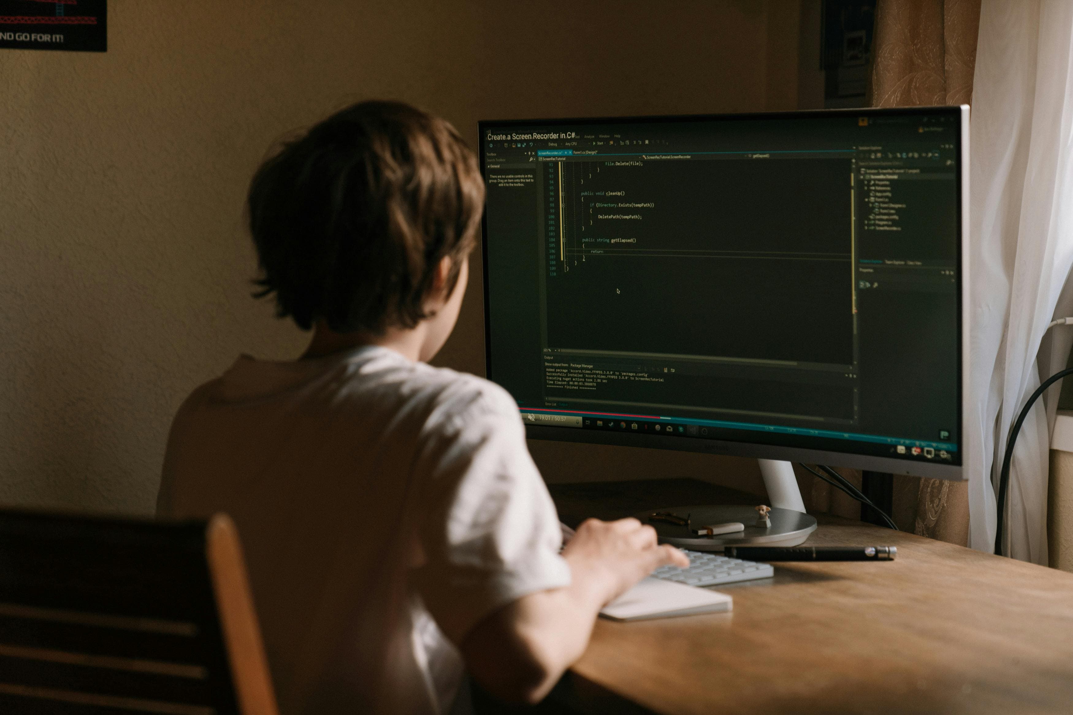 A desk setup with a large monitor positioned directly in front of a seated user.