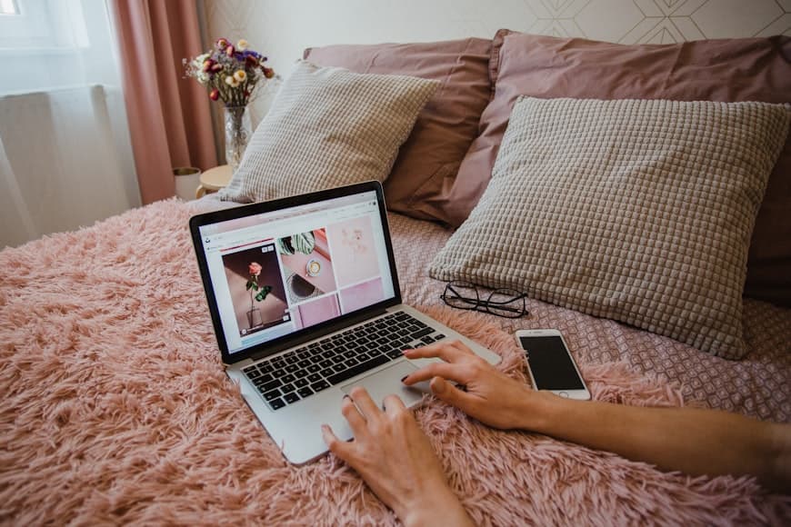 A calm bedroom workspace with a desk, chair, and soft daylight in a compact room.