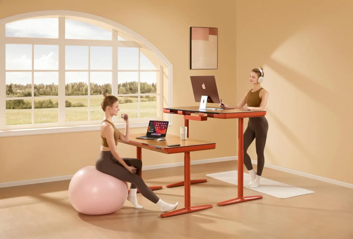 A compact standing desk setup with minimal accessories in a bright room.