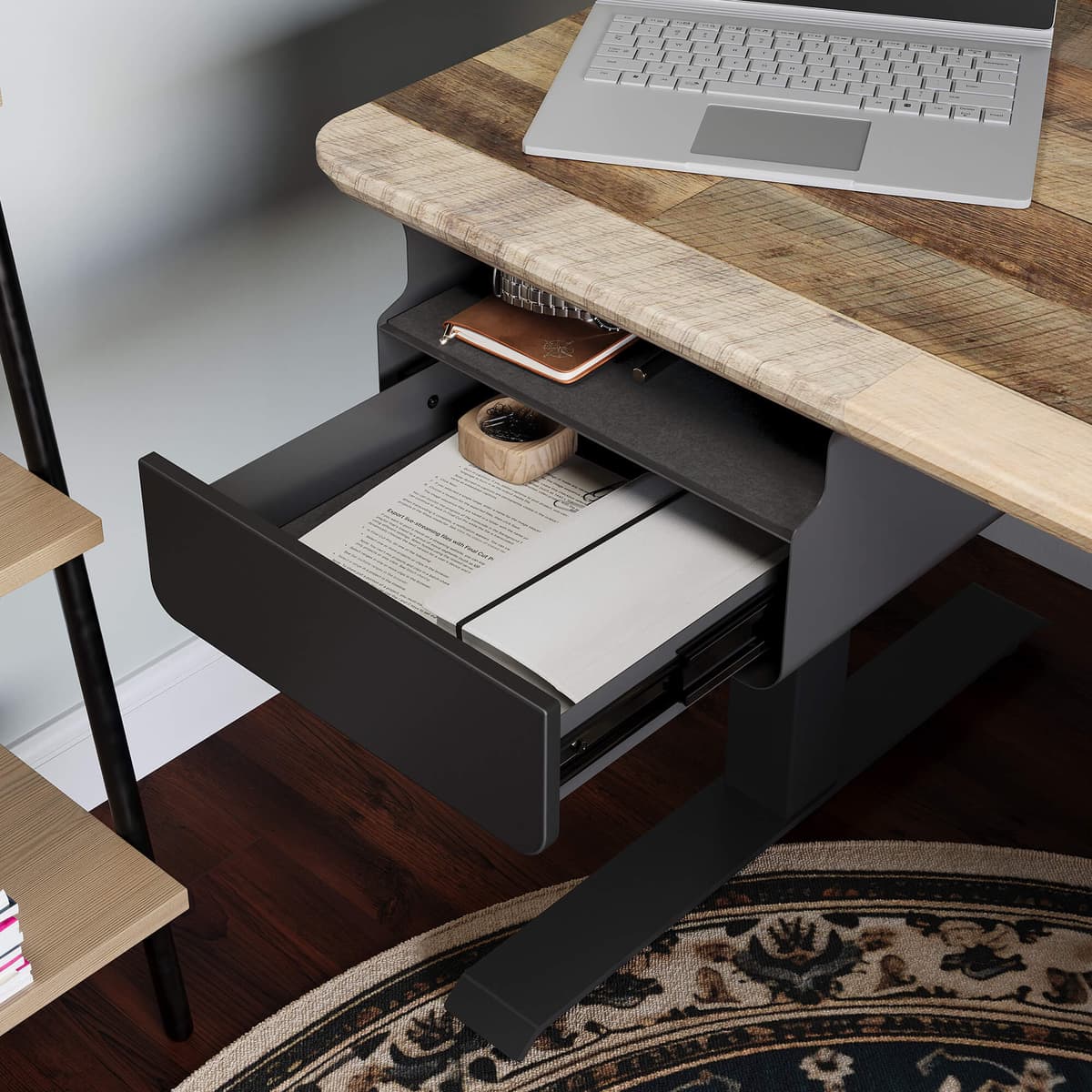 A slim under-desk storage unit mounted beneath a standing desk with a clean desktop above it.