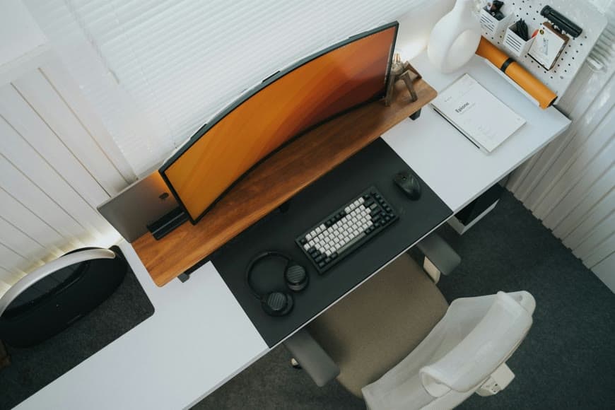 A refined desk setup with layered lighting and a calm, polished workspace.