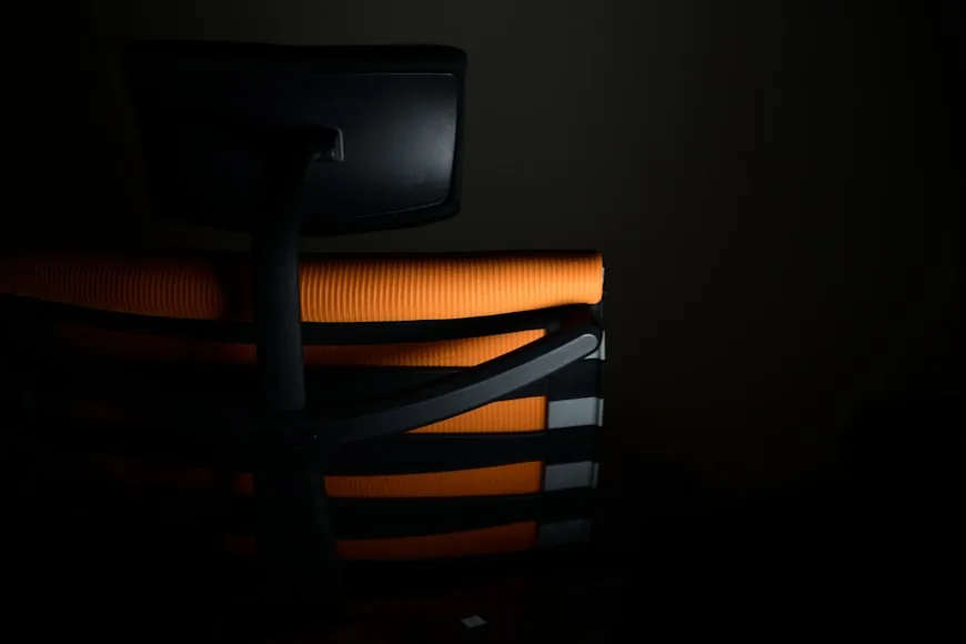 A clean desk setup with a comfortable chair in a modern workspace.