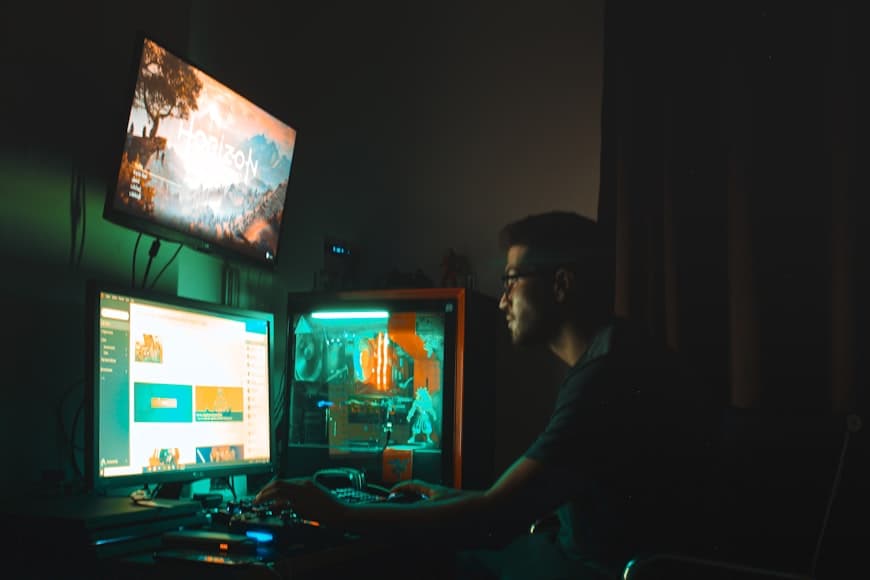A monitor with reflections from a bright workspace.