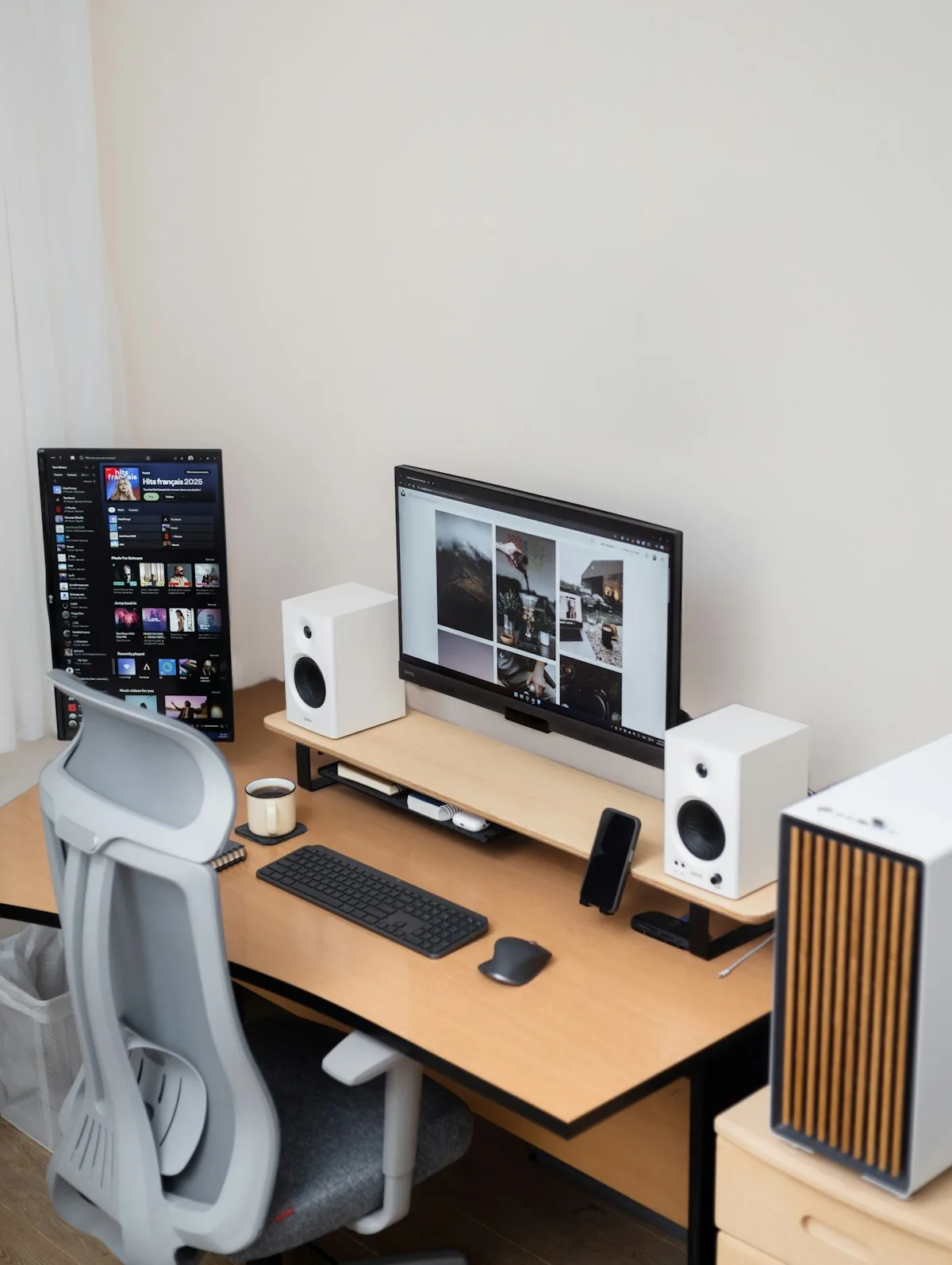 A dual‑monitor desk setup with speakers and a tidy work surface.