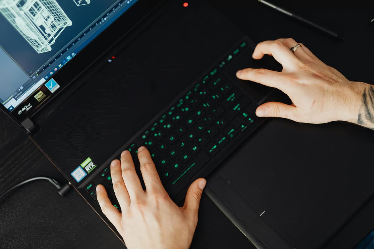 Hands typing on a keyboard at a desk, illustrating repeated keyboard input problems.