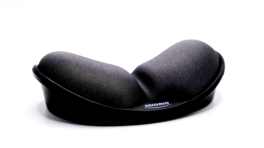 A black ergonomic wrist rest photographed on a white background.