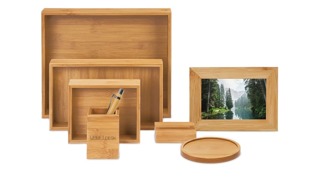 The UPLIFT Bamboo Desk Organizer Set arranged with multiple boxes and small desktop accessories.