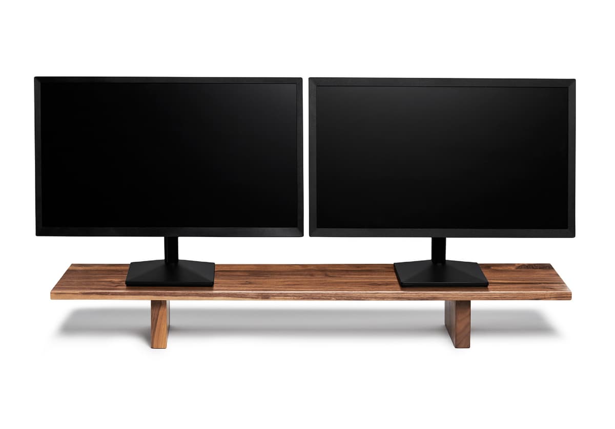The Ergonofis Desk Shelf in a workspace with monitors and accessories arranged above and below the shelf.