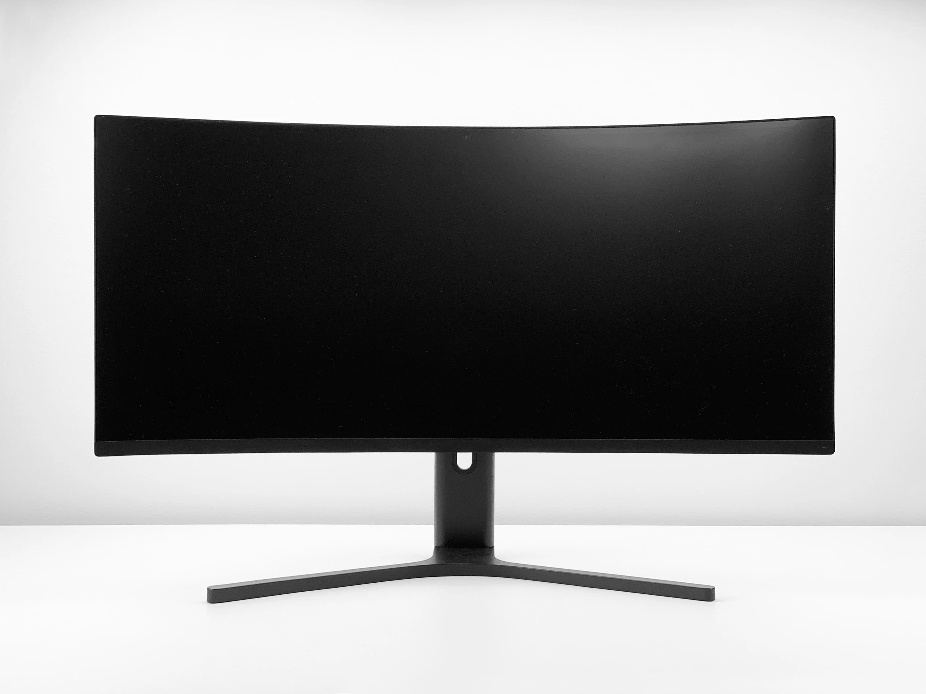A modern gaming monitor showing vivid game visuals on a clean desk setup.
