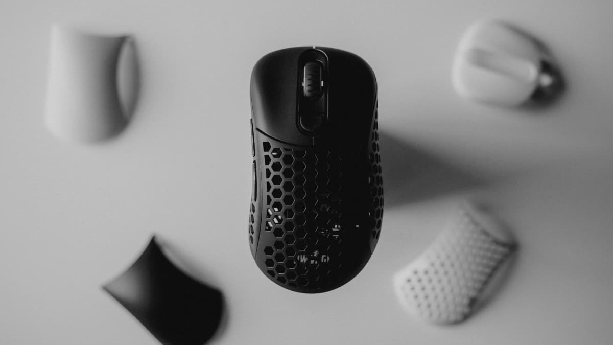 A variety of modern high-performance mice arranged on a clean workspace desk.