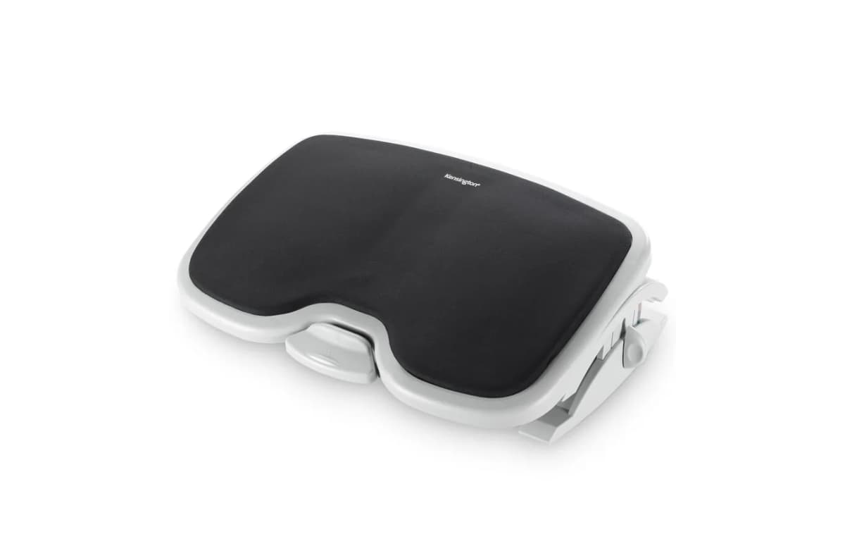 A black cushioned office footrest with a gray adjustable base viewed at an angle.