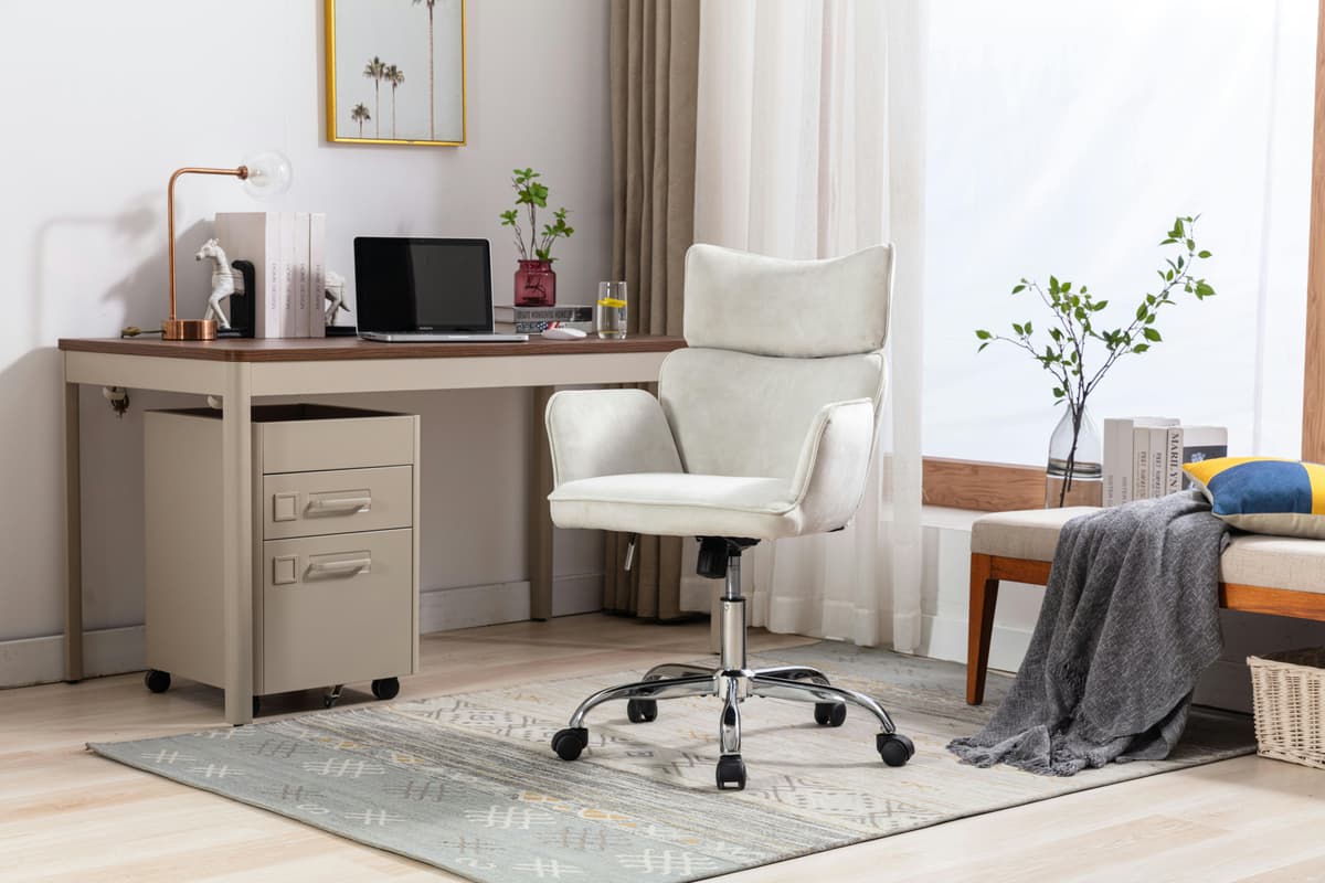 A compact home office with an ergonomic chair tucked beside a desk.