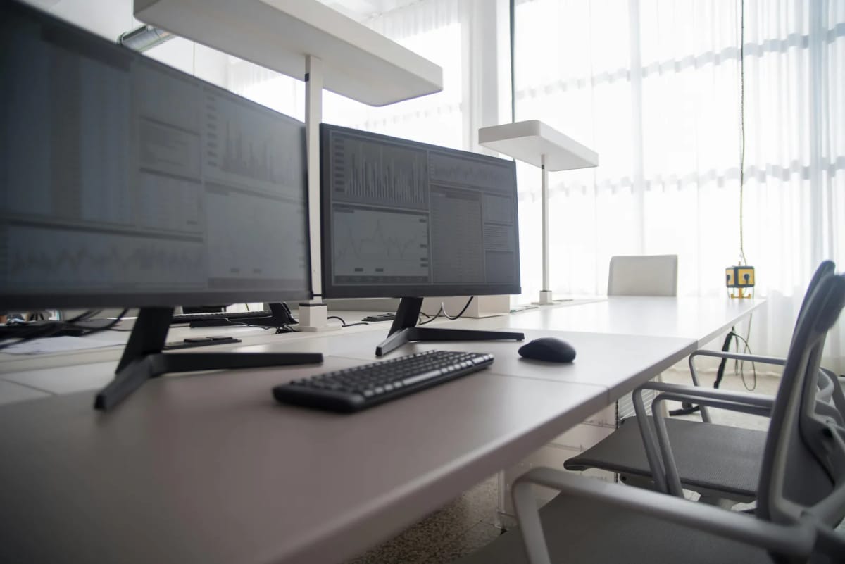A deep office desk setup with dual monitors, keyboard, and mouse arranged with extra front-to-back space.