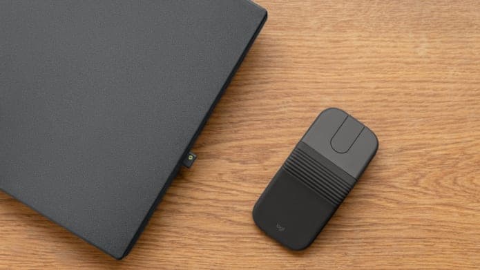 Logitech Mobi Fold wireless mouse shown in both folded and unfolded positions on a checkerboard surface.