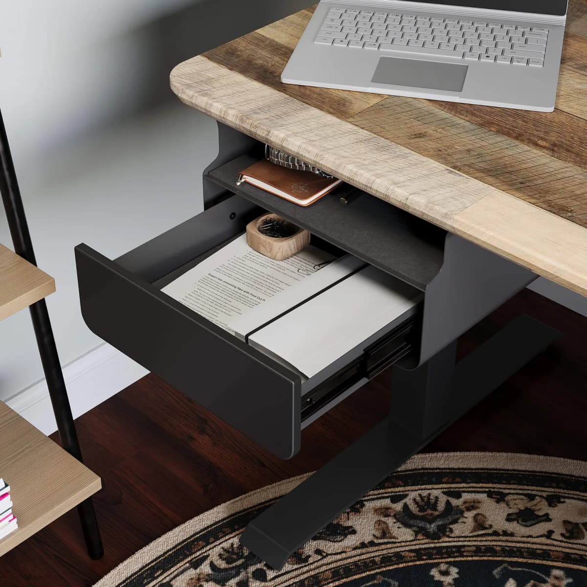 A slim under-desk storage unit mounted beneath a standing desk with a clean desktop above it.