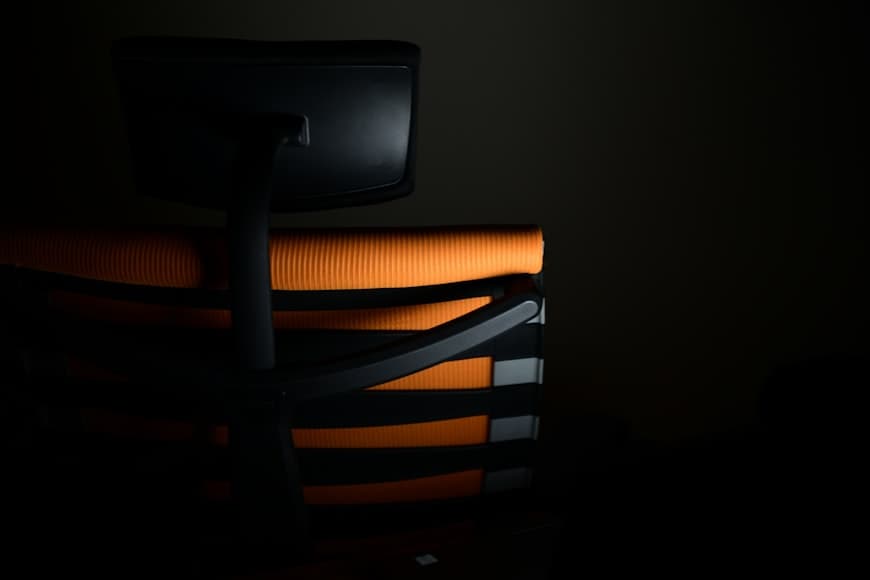 A clean desk setup with a comfortable chair in a modern workspace.