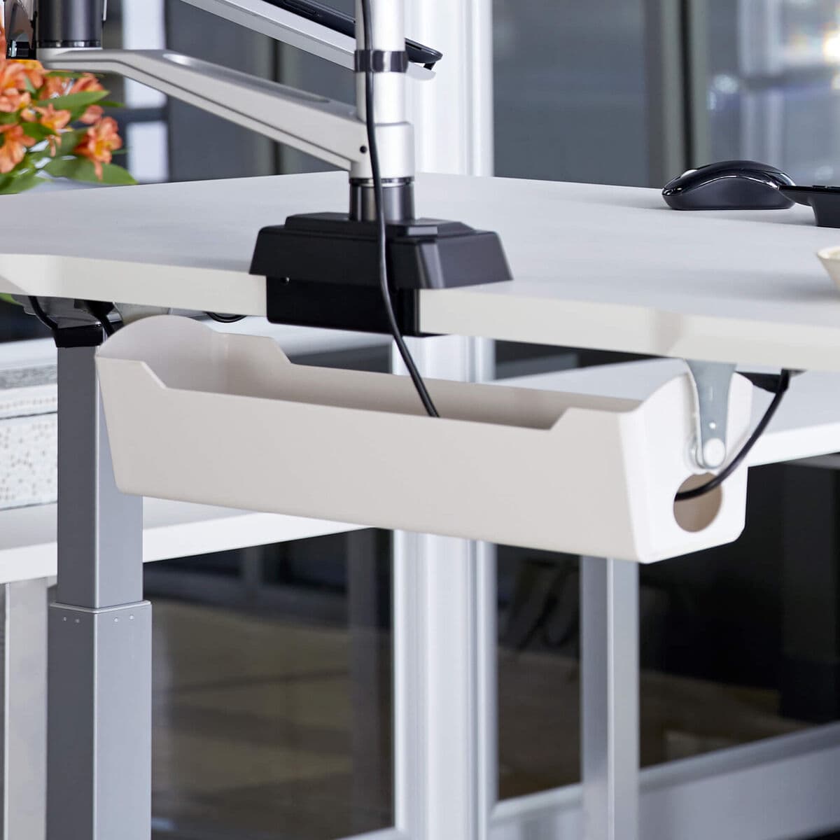 Vari Cable Management Tray mounted beneath a standing desk.