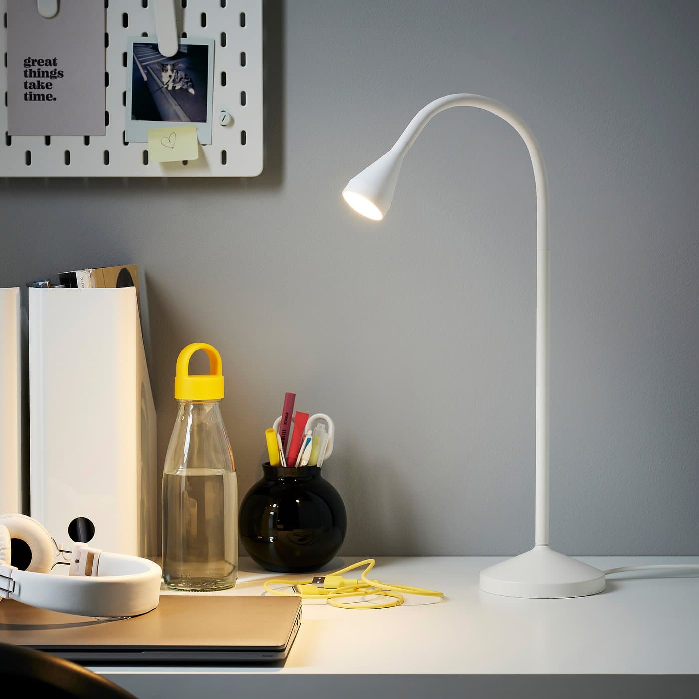 IKEA NÄVLINGE LED work lamp on a compact desk in an official product image.