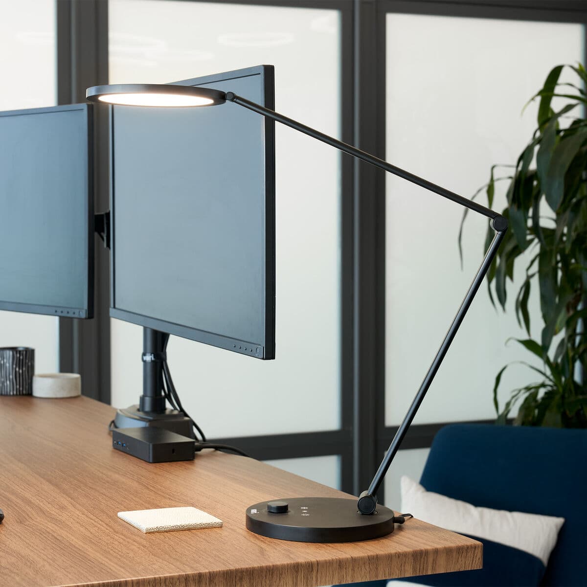 Vari Studio Lamp in use beside a monitor on a desk in an official product image.