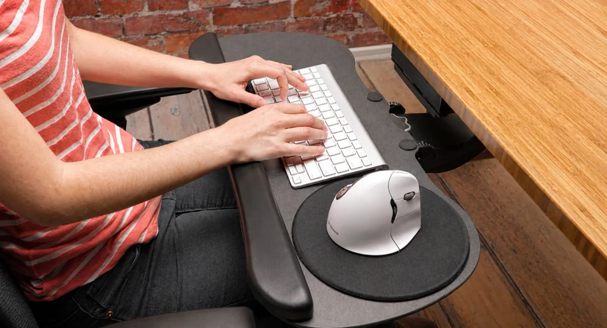 A backlit mechanical keyboard on a desk, photographed from a low angle.
