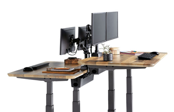 Vari Essential Electric Standing Desk 48x24 in a compact office setup.